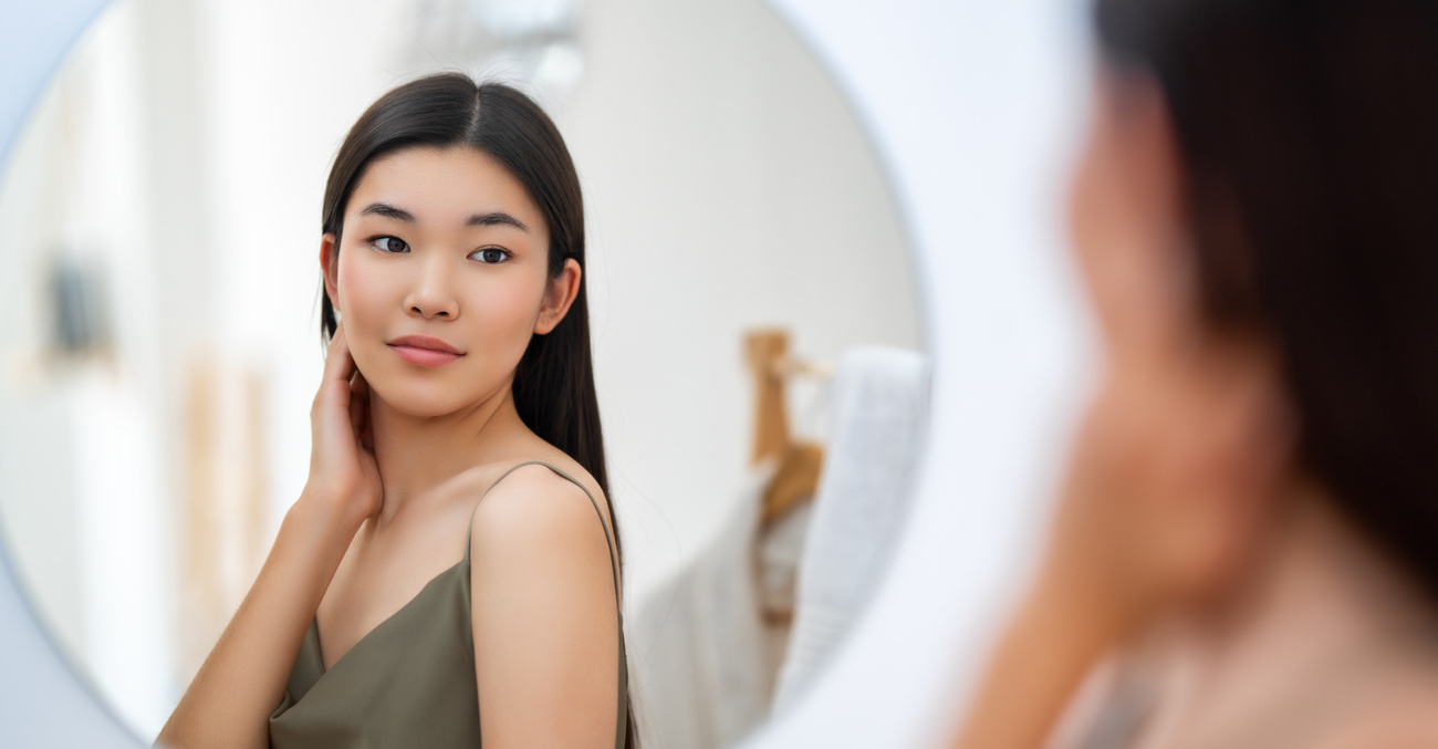 woman looking at mirror